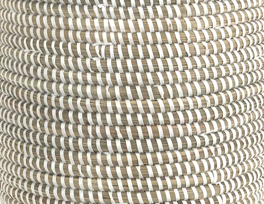 White woven catch-all basket used for indoor storage and plants.