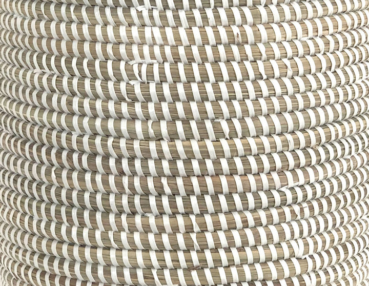 White woven catch-all basket used for indoor storage and plants.