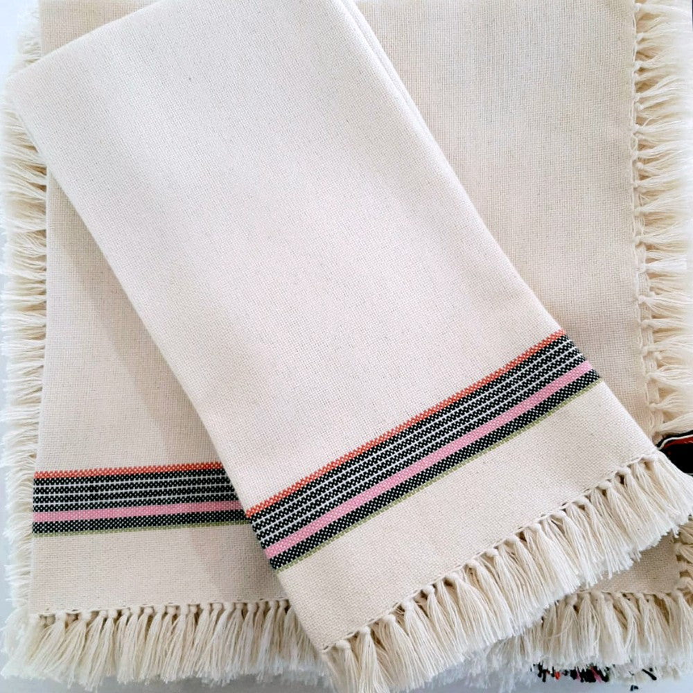 Detail of the handwoven fringe napkin showing knotted fringe on soft cotton.