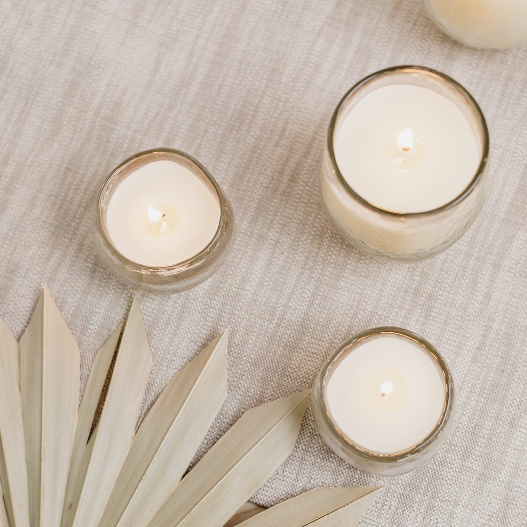 Soy wax votive candle set of three with reusable textured glass vessels.