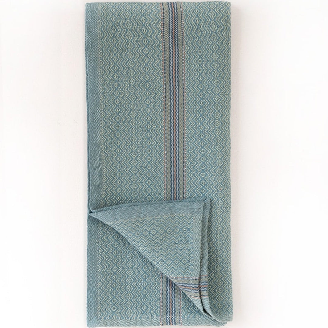 Set of four Mungo cotton dinner napkins in cumin, ginger, mint, and truffle.