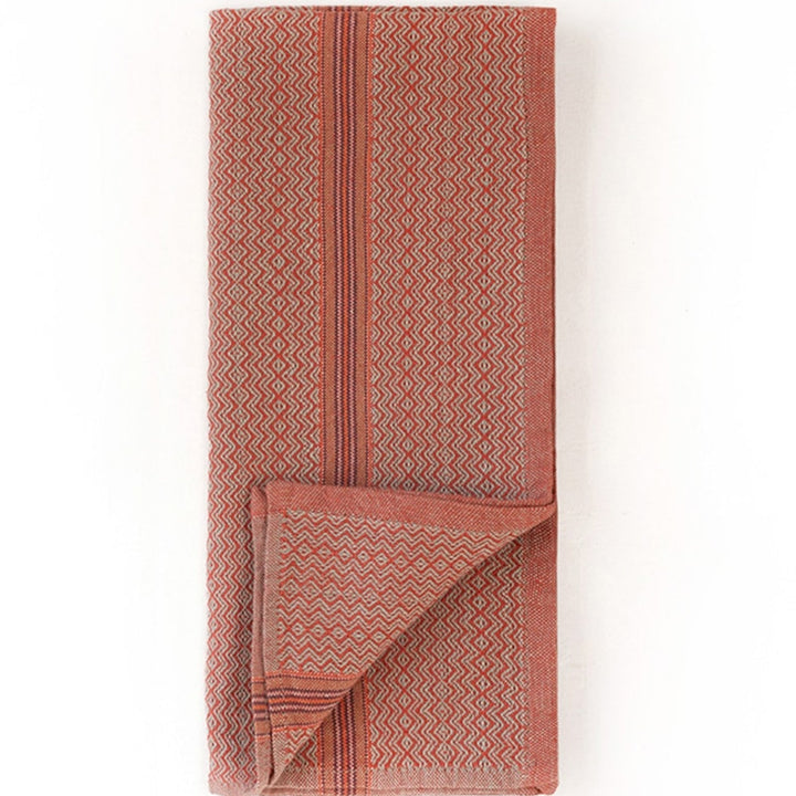 Folded multicolor cotton napkins in cumin, ginger, mint, and truffle.