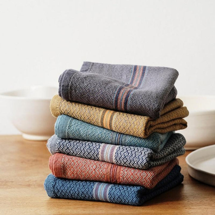 Set of four multicolor cotton napkins in cumin, ginger, mint, and truffle.