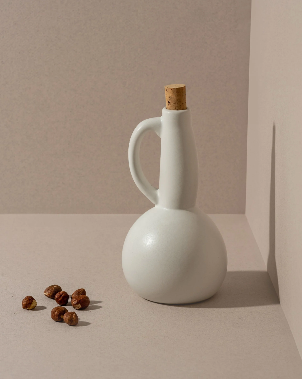 Handmade Tunisian stoneware olive oil dispenser with a matte glaze and pour spout.
