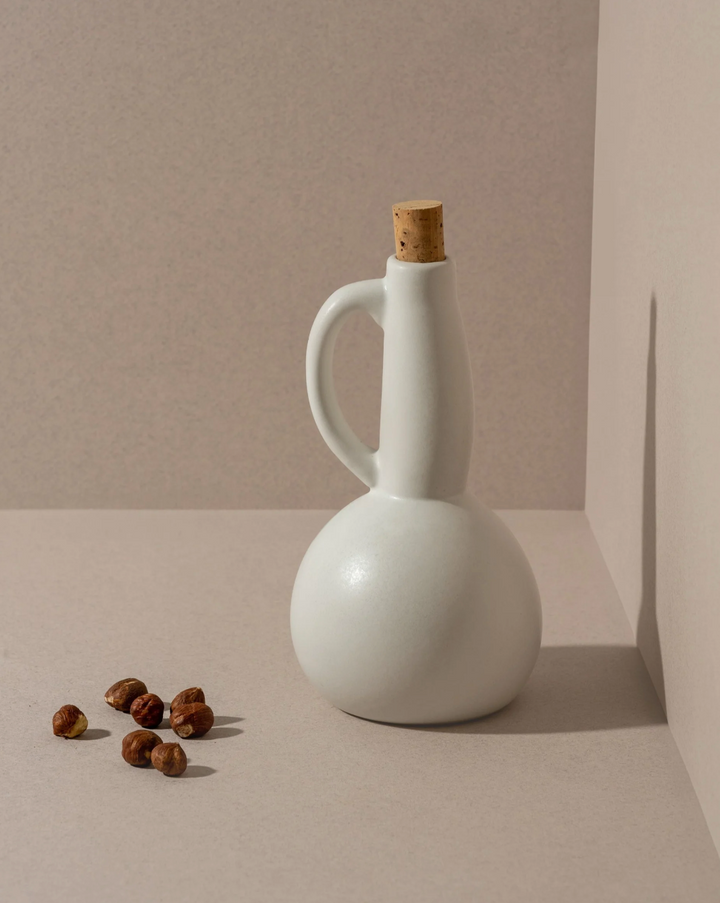 Handmade Tunisian stoneware olive oil dispenser with a matte glaze and pour spout.
