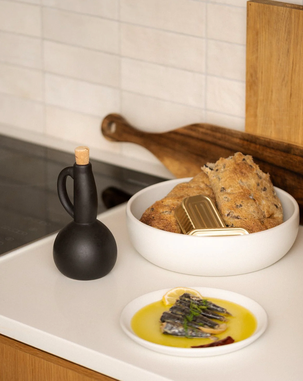 Stoneware olive oil bottle with a pour spout and handle, handcrafted in Tunisia.