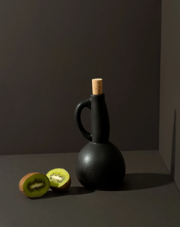 Matte-glazed stoneware olive oil dispenser with a handle, made in Tunisia.