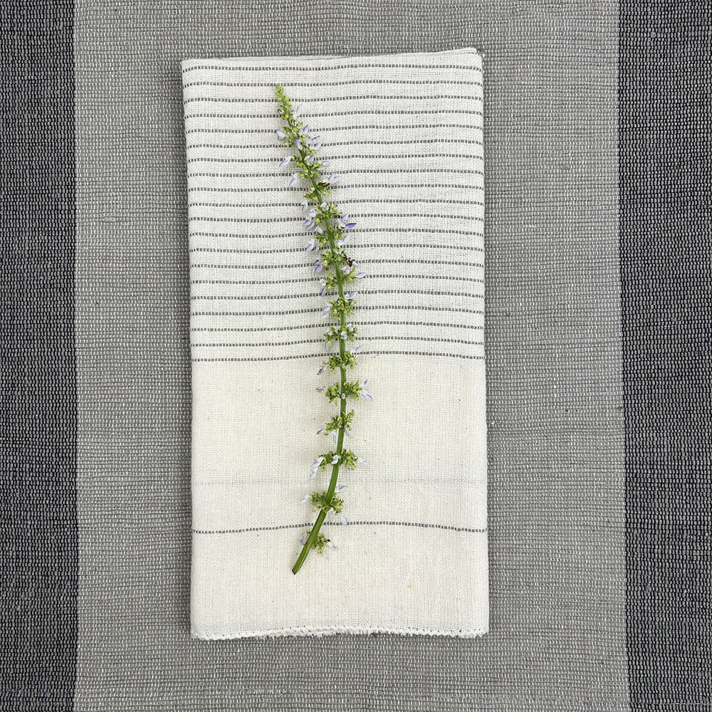 Black Hamptons handloom dinner napkins with embroidered design and textured fabric.