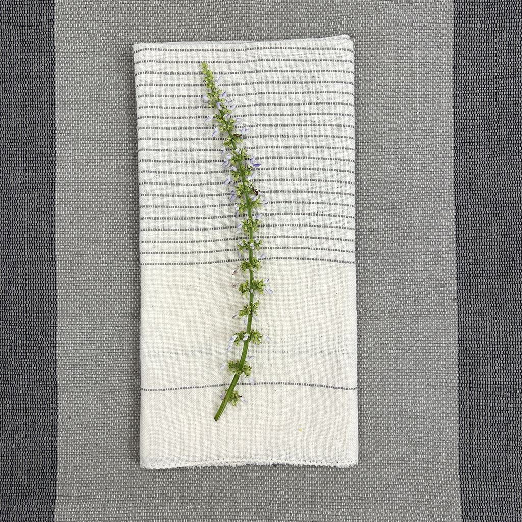Black Hamptons handloom dinner napkins with embroidered design and textured fabric.