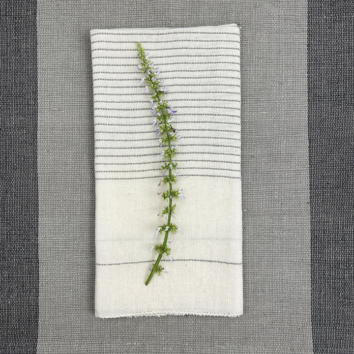 Black Hamptons handloom dinner napkins with embroidered design and textured fabric.