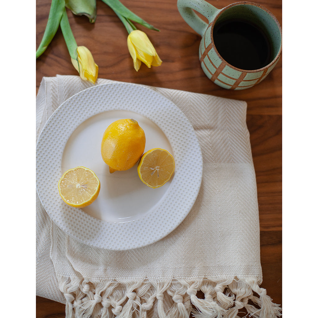 Champagne herringbone Turkish cotton hand towel draped on a wooden surface.