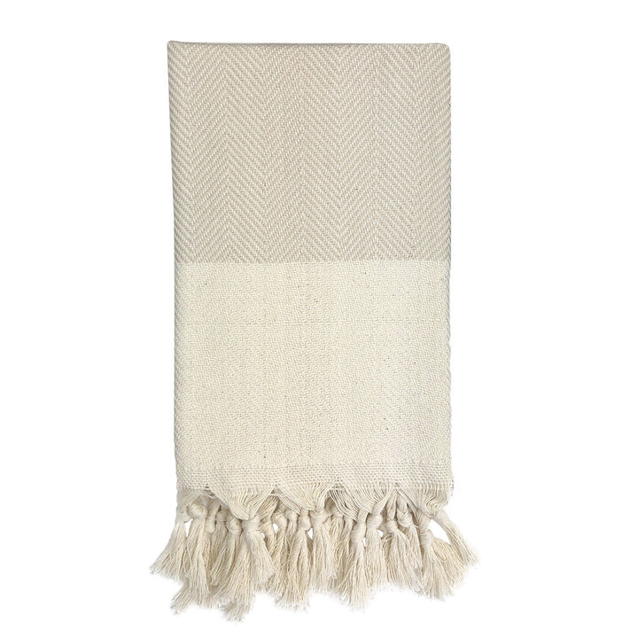 Champagne herringbone Turkish cotton hand towel with a textured pattern.