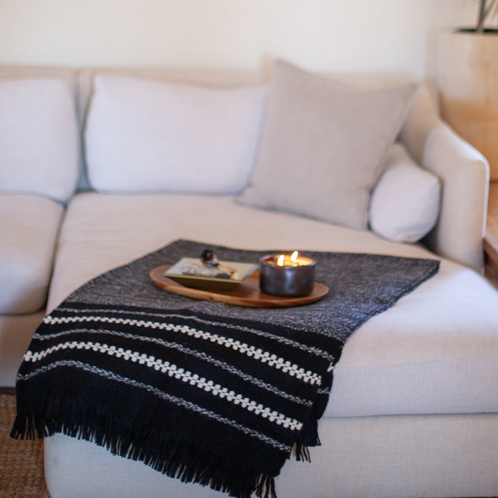 Black and cream striped alpaca throw blanket with a thick, soft weave