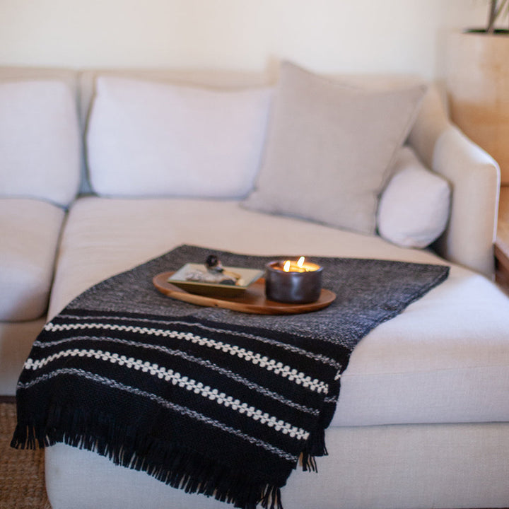 Black and cream striped alpaca throw blanket with a thick, soft weave
