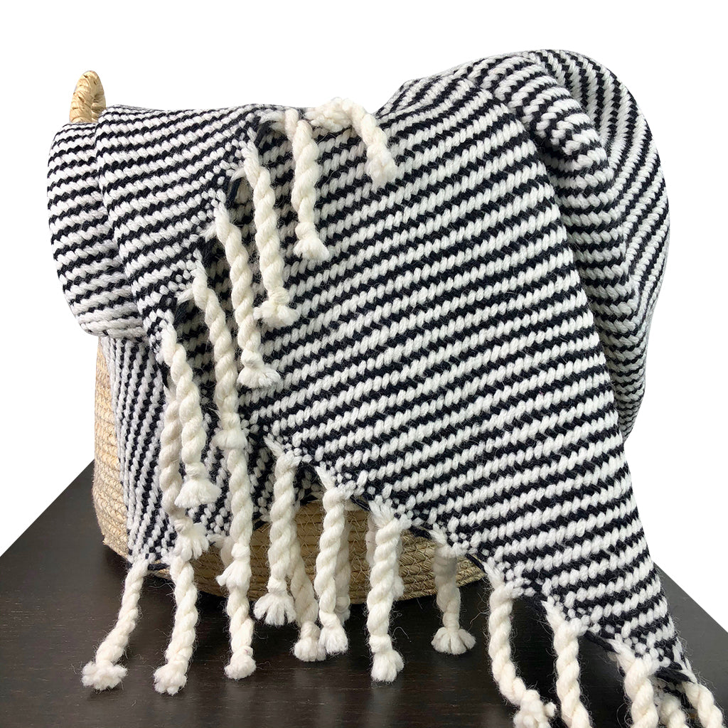 Chunky black stripe alpaca throw blanket with warm, woven texture and bold stripes.
