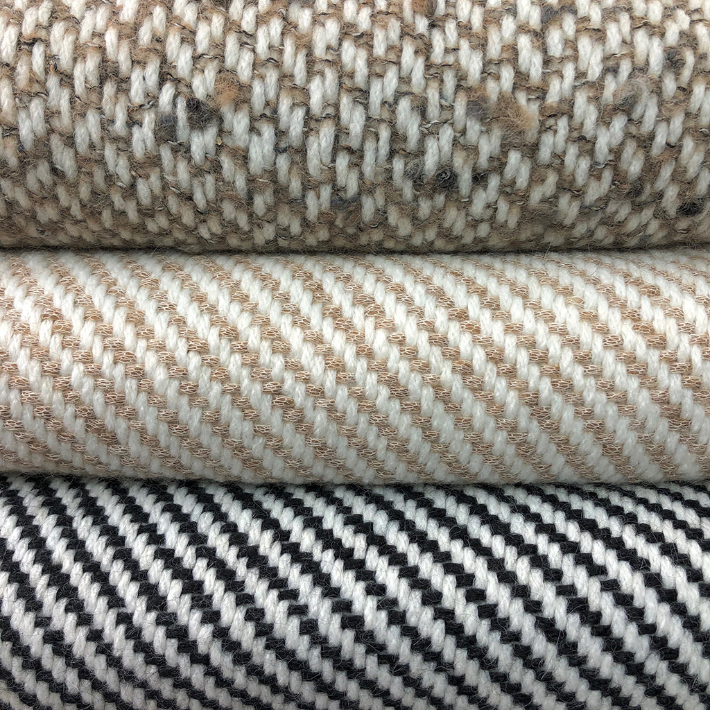 Chunky camel stripe alpaca throw with a bold striped pattern in natural tones.