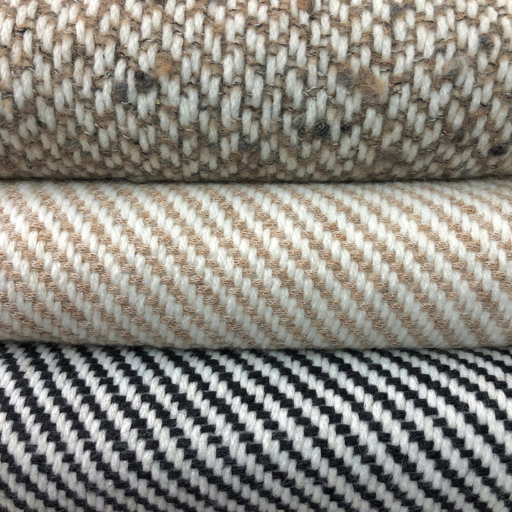 Chunky camel stripe alpaca throw with a bold striped pattern in natural tones.