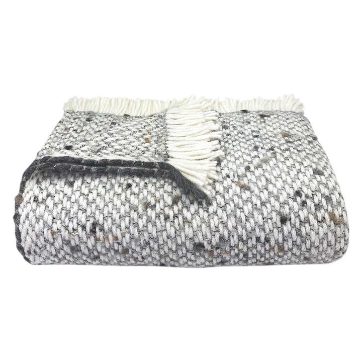 Chunky gray weave alpaca throw blanket, soft and textured for warmth.