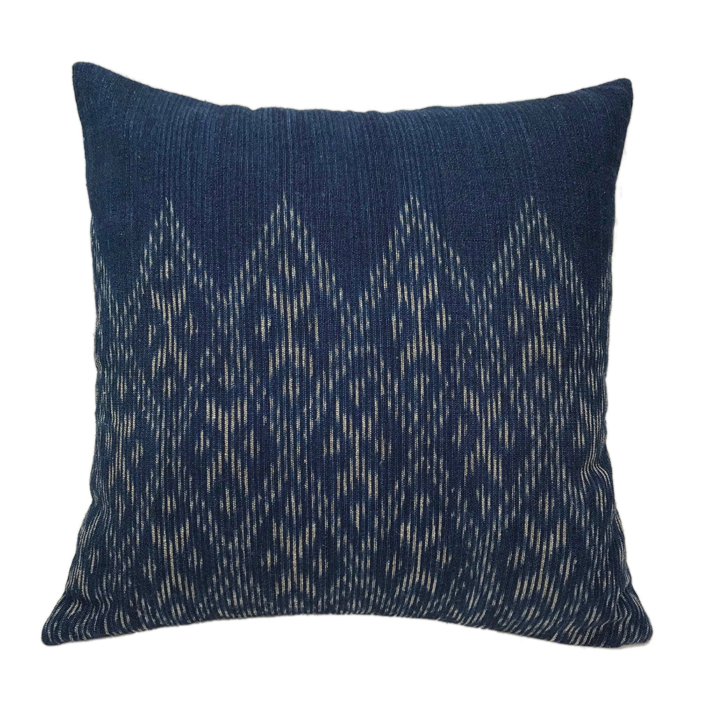 Hand-dyed indigo diamond pillow cover with a woven diamond pattern.