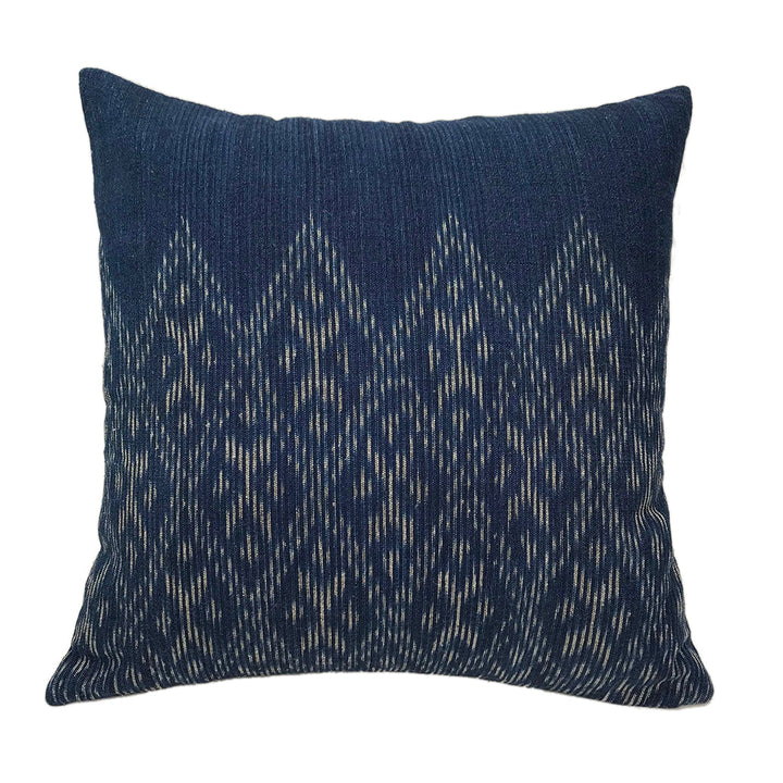 Hand-dyed indigo diamond pillow cover with a woven diamond pattern.