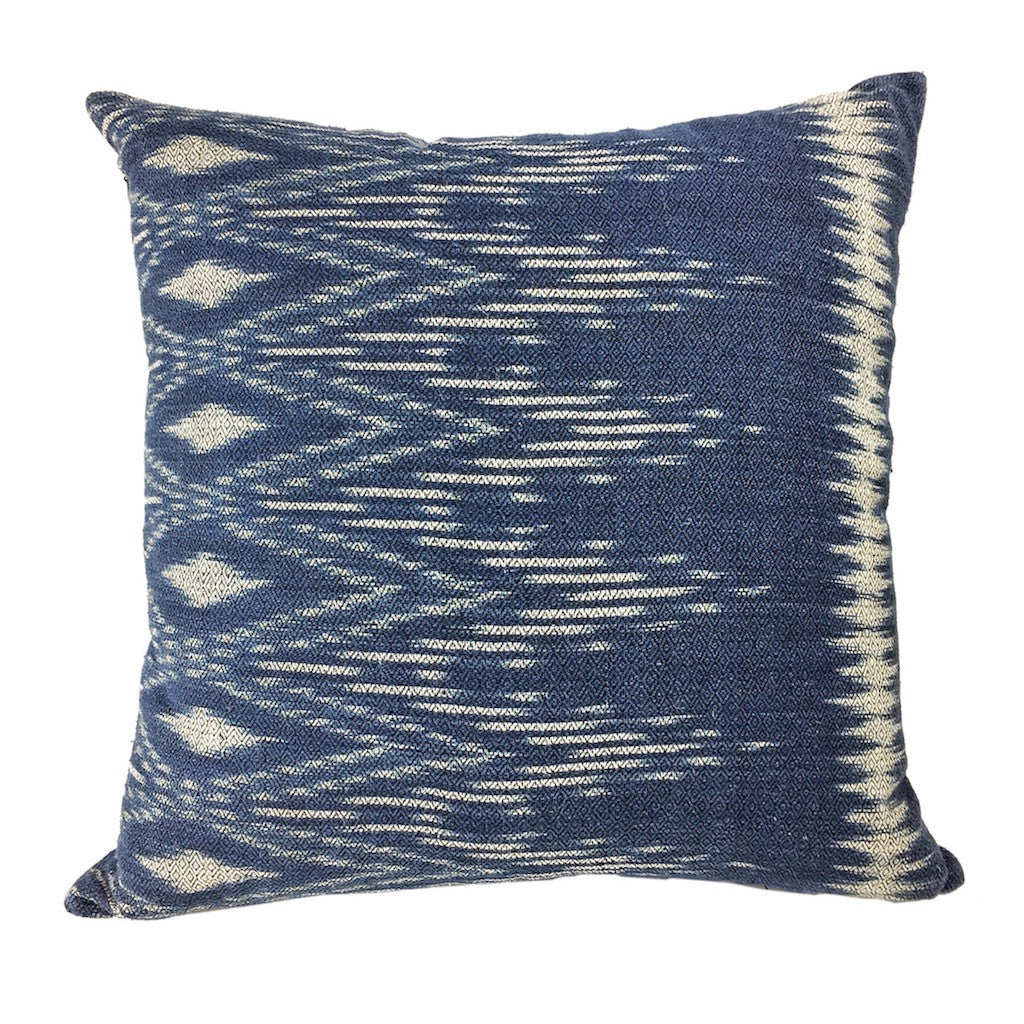 Handwoven indigo ikat pillow cover with a traditional ikat pattern.