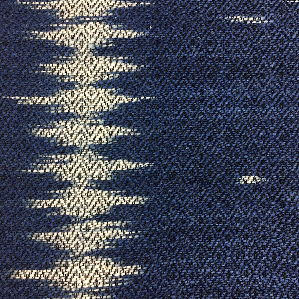 Handwoven indigo ikat pillow cover with intricate ikat patterns on soft fabric.