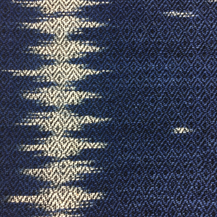 Handwoven indigo ikat pillow cover with intricate ikat patterns on soft fabric.