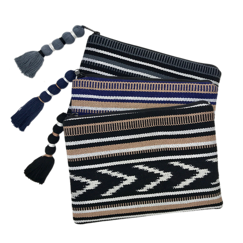 Indigo and tan ikat backstrap clutch with woven fabric and a compact design.
