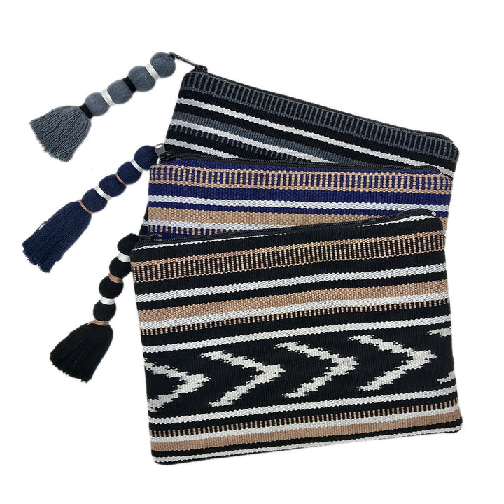Indigo and tan ikat backstrap clutch with woven fabric and a compact design.