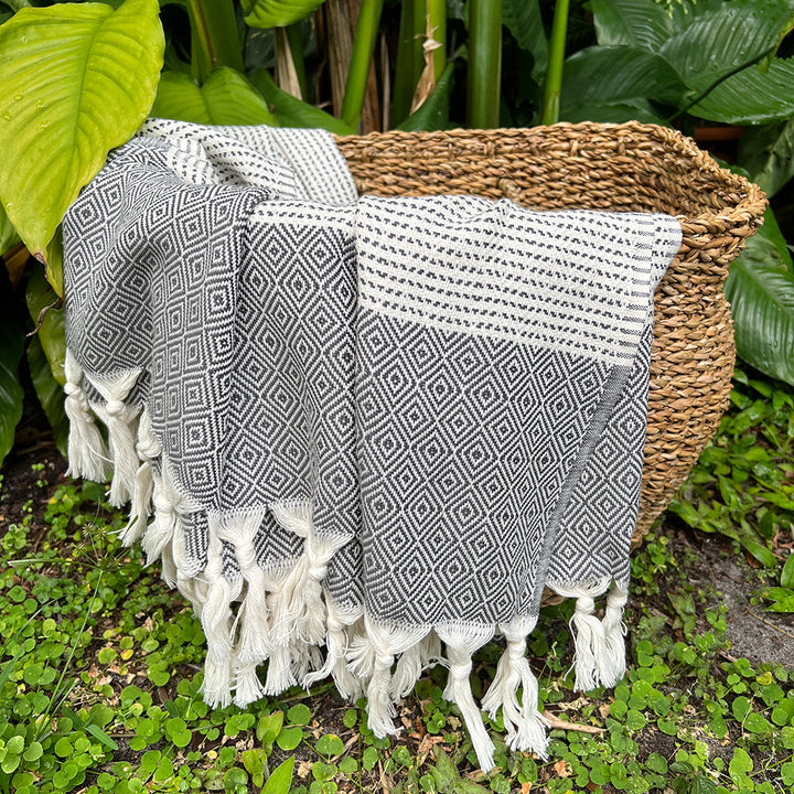 Turkish throw blanket with a diamond stripe pattern in lilac and gray.