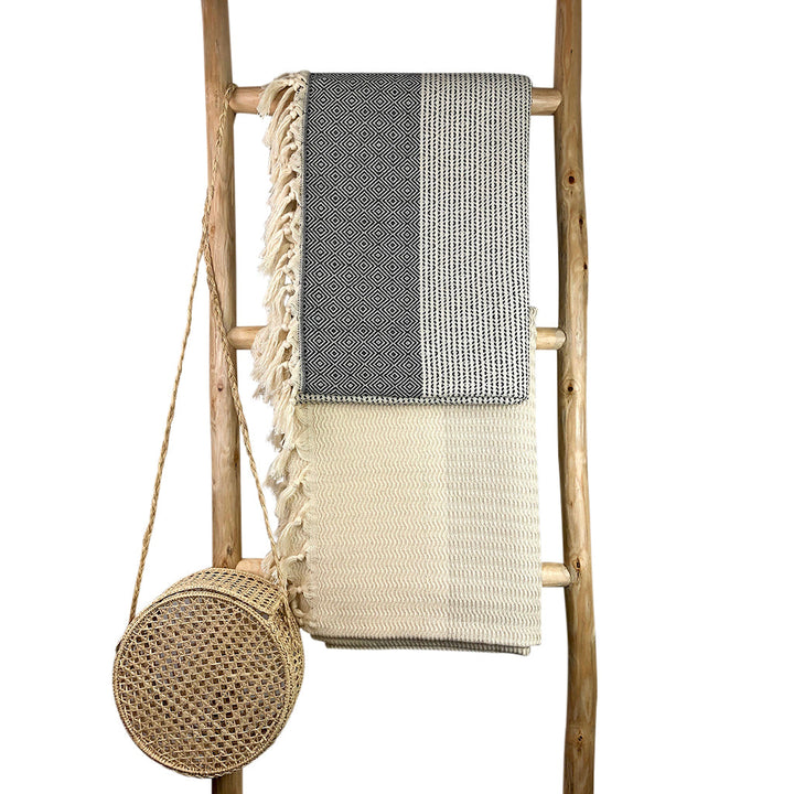 Turkish throw blanket with a lilac and gray diamond stripe pattern.