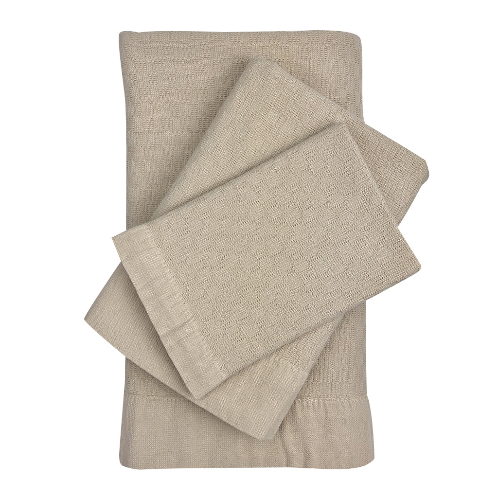 Set of 3 Turkish towels (bath, hand, washcloth) in oat with a woven texture.