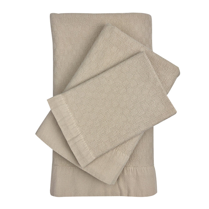 Set of 3 Turkish towels (bath, hand, washcloth) in oat with a woven texture.