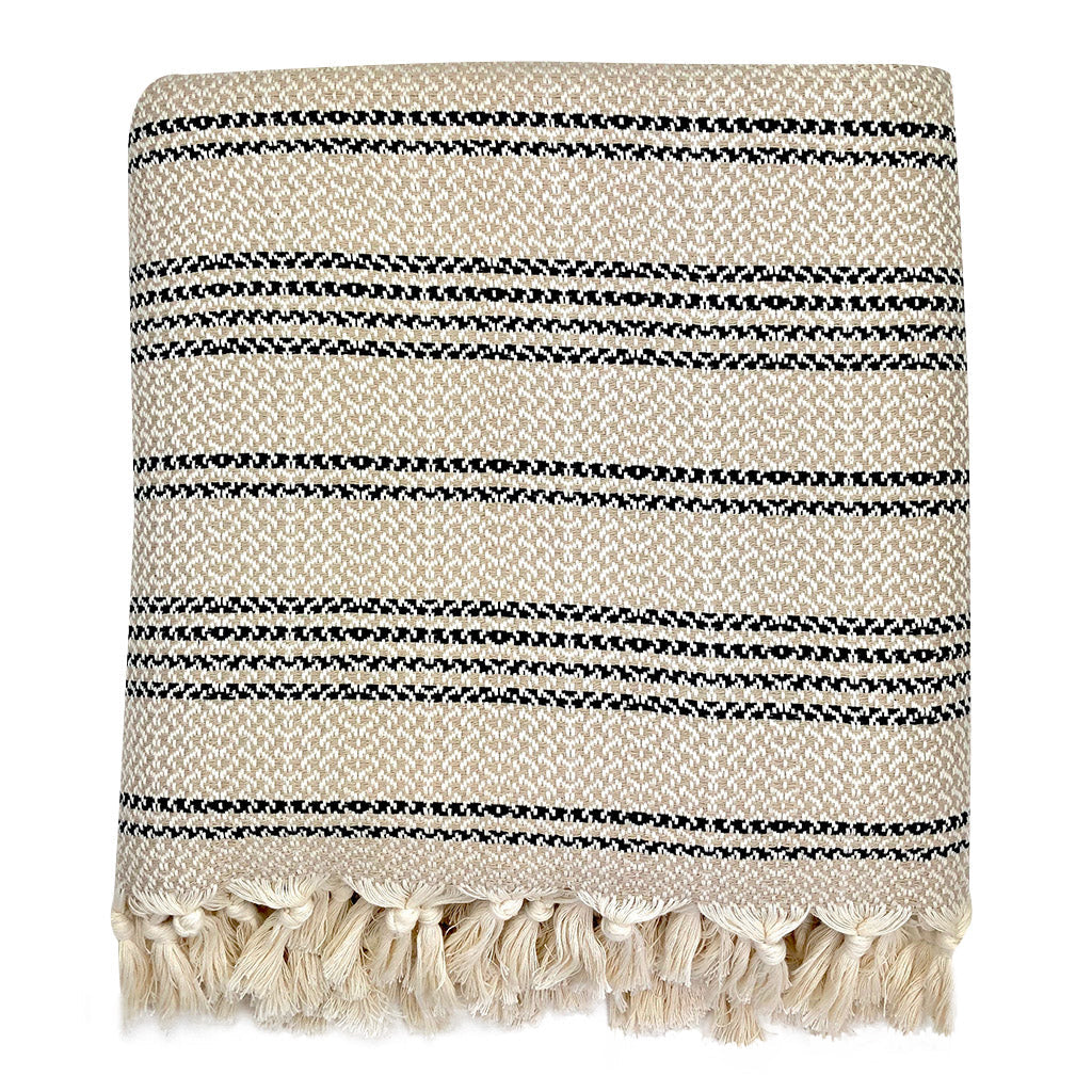 Woven stripe Turkish throw in sand and ivory with a striped pattern.