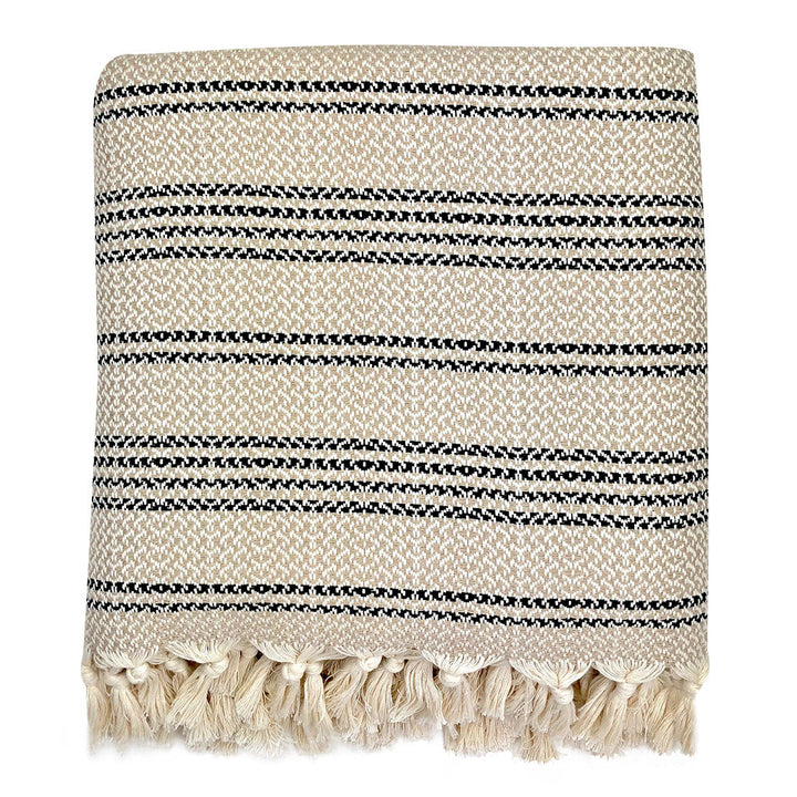 Woven stripe Turkish throw in sand and ivory with a striped pattern.