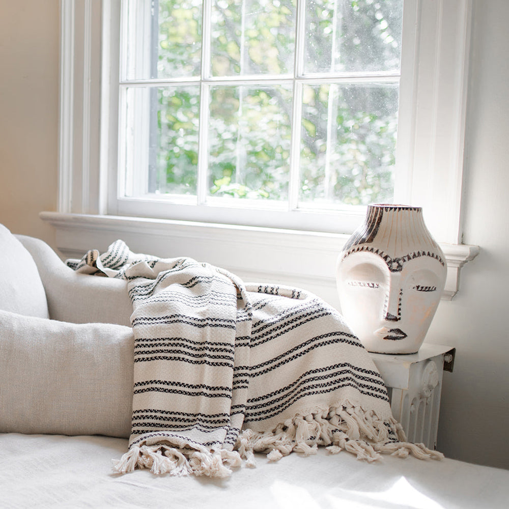 Woven stripe Turkish throw in sand and ivory with a textured striped pattern.