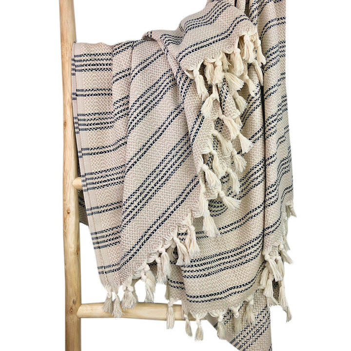 Woven stripe Turkish throw in ivory and sand with blue accents.