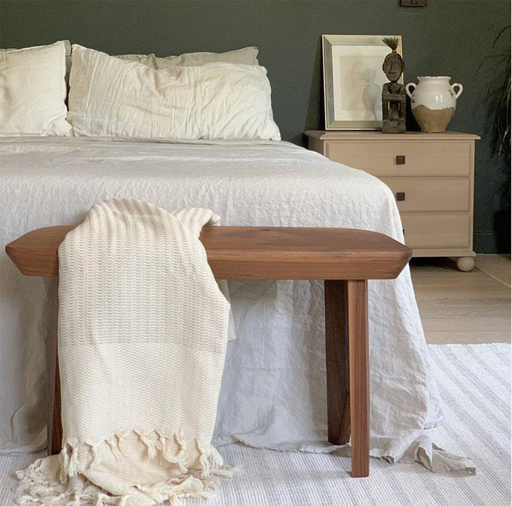 Soft plush wavy Turkish throw in sandy beige, folded on an armchair.