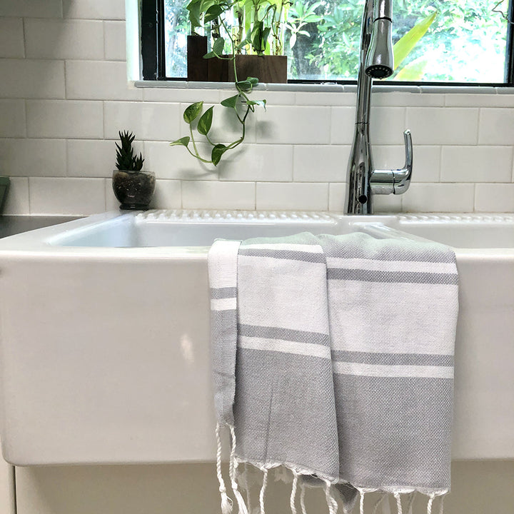 Steel gray Turkish hand towel with a stripe pattern and absorbent cotton.