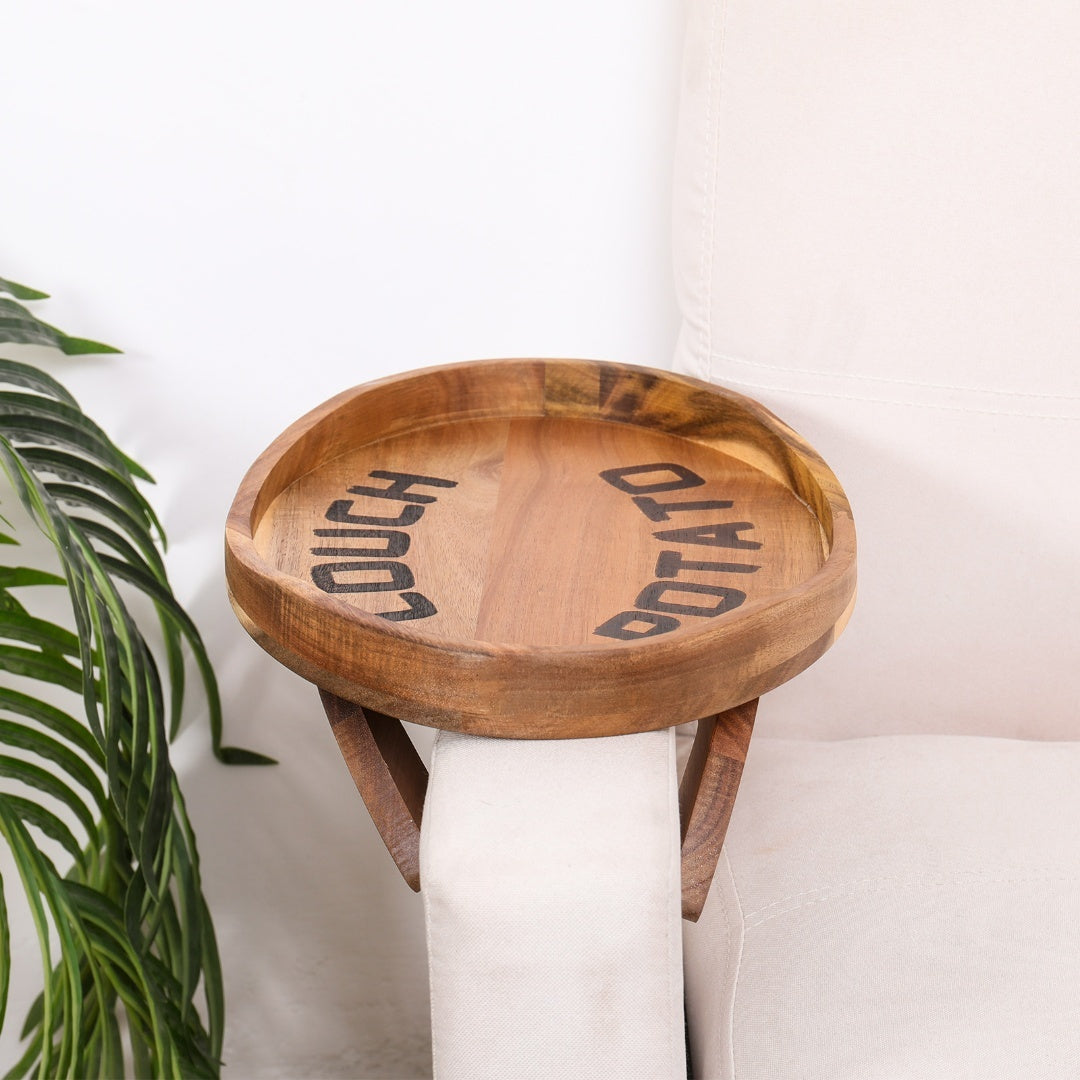 Couch Potato Clip-On Sofa Tray made of acacia wood with a sleek design, attached to a sofa armrest for convenient use.