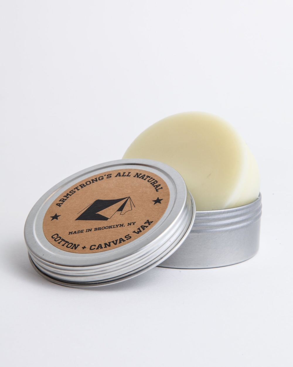 Cotton canvas waterproofing wax shown with a wax puck and a fabric swatch.
