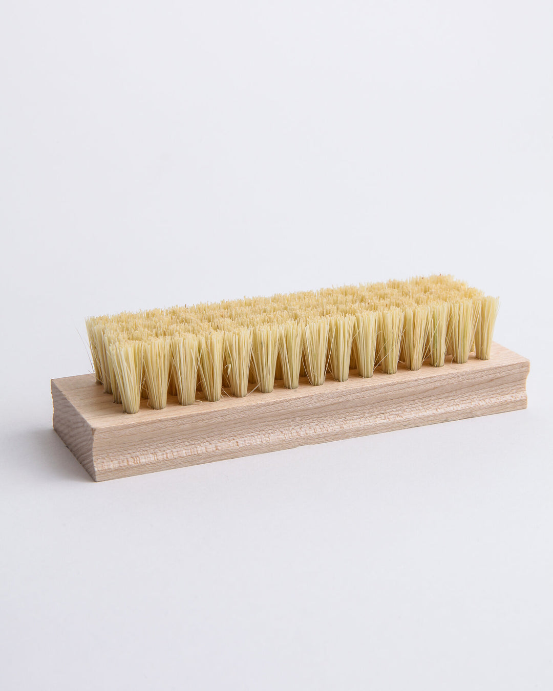 Tampico scrub brush with stiff natural vegetable-fiber bristles for cleaning.