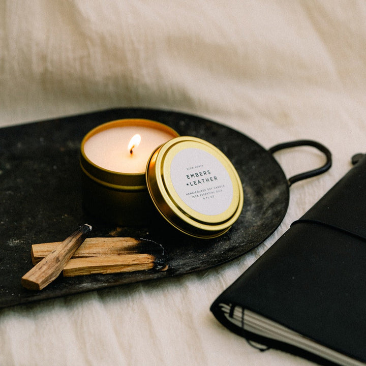 6 oz Embers &amp; Leather candle in a brushed gold tin with warm, earthy scent.