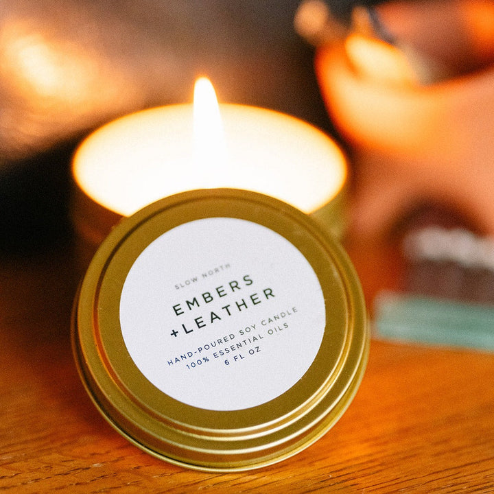 6 oz Embers &amp; Leather travel tin candle with warm vetiver cedar patchouli scent.