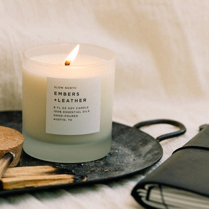 8 oz Embers &amp; Leather signature candle with warm woody scent and textured design.