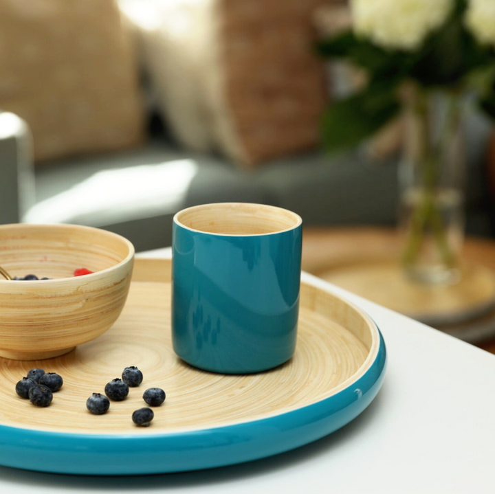 Ly bamboo mug in a natural finish with a handle.