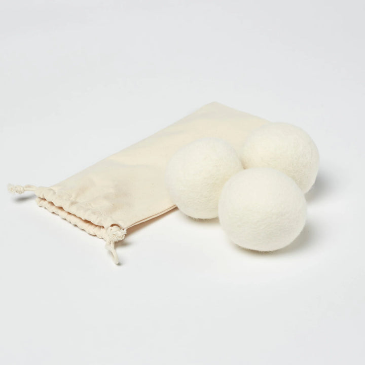 Set of three LanaDown wool dryer balls, made from pure wool to soften laundry naturally.