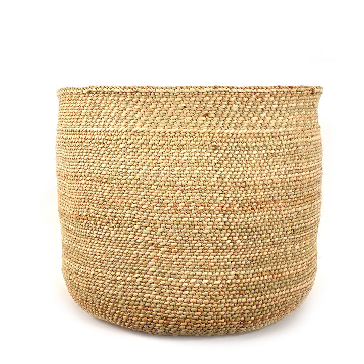 Natural Iringa grass basket, side view showing the plaited braid finishing the top edge