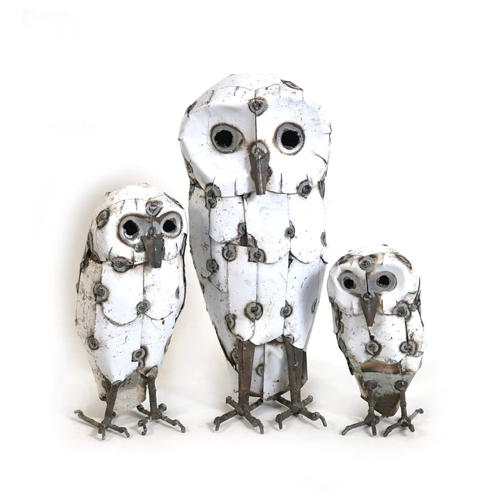 Handcrafted recycled metal snowy owl sculpture with detailed feathers, perched.