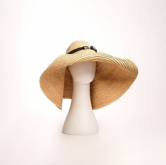 Close-up of the Grand Belmont wide-brim straw sun hat, showing its natural braided weave.